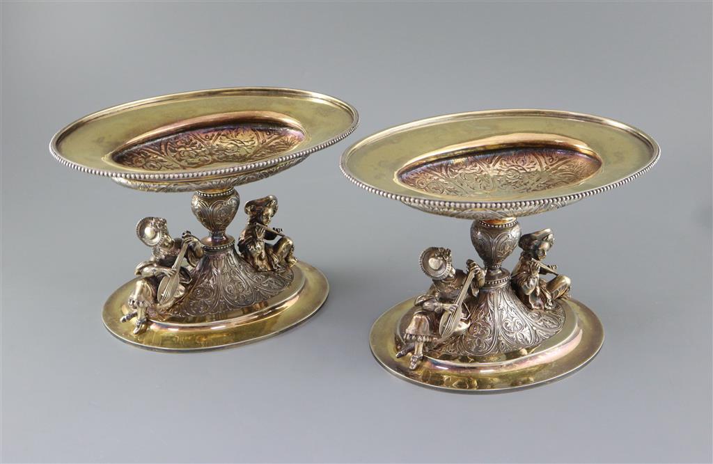 A handsome pair of Victorian parcel gilt silver oval comports by Hunt & Roskell (lacking glass bowls),